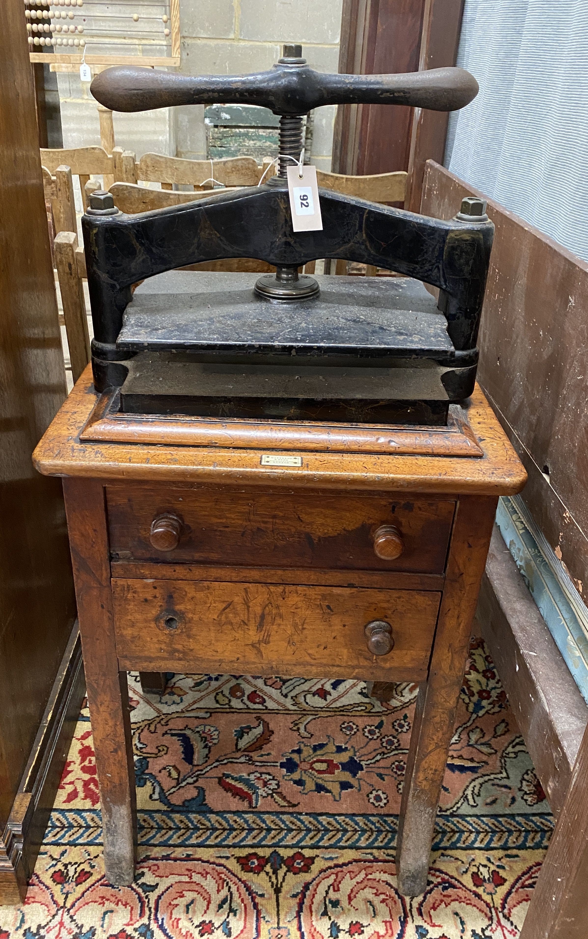 A Victorian cast iron book press on mahogany stand, marked Waterlow & Son, London, width 55cm, depth 43cm, height 118cm